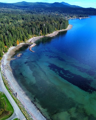 Aerial view of Texada Island with turquoise water, rocky shoreline, and coastal road