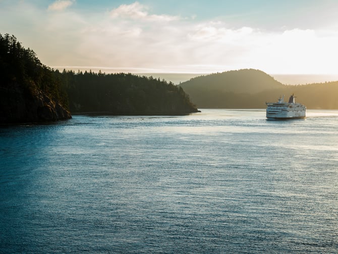 Fishing charter boat on calm coastal waters near Texada Island with forested shoreline in background
